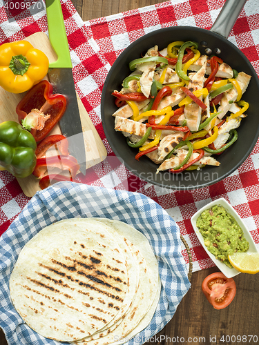 Image of delicious wrap tortilla with spicy chicken vegetables guacamole