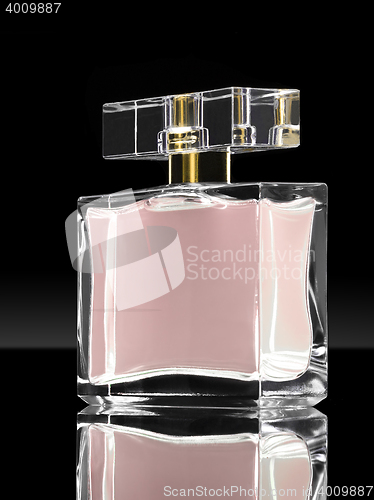 Image of pink elegant perfume bottle in black background