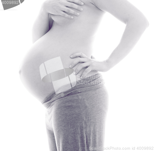 Image of Pregnant Woman holding her hands on beautiful belly