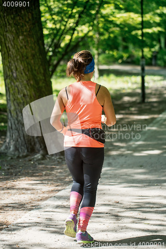 Image of Young female jogger in park