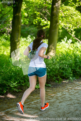 Image of Young female jogger in park