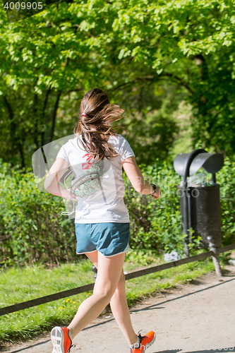 Image of Young female jogger in park
