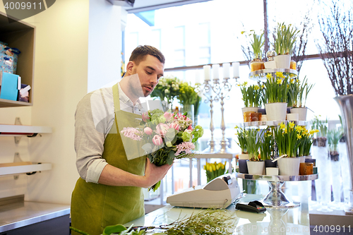 Image of florist man making bunch at flower shop