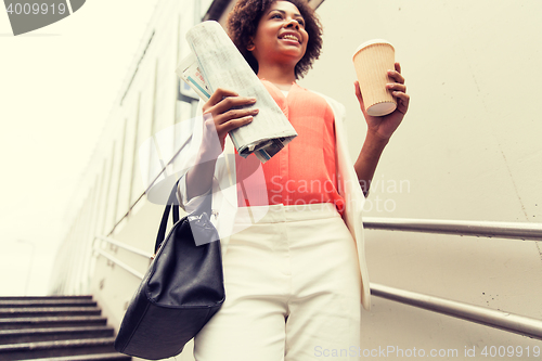 Image of close up of woman with coffee and newspaper