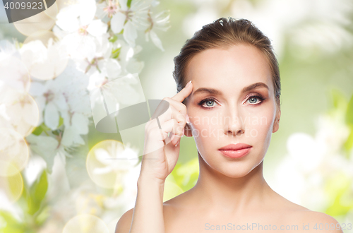 Image of beautiful young woman showing her forehead
