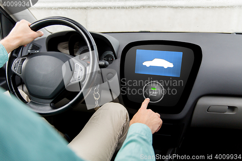 Image of close up of man in car with starter on computer