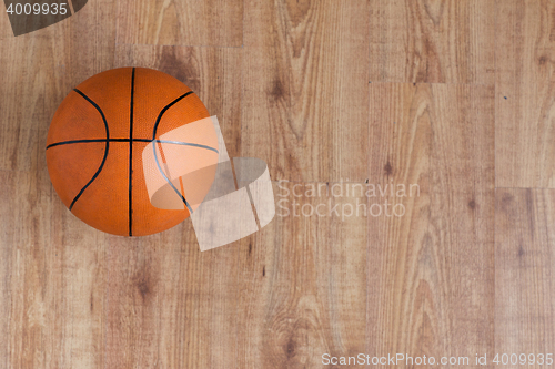 Image of close up of basketball ball on wooden floor