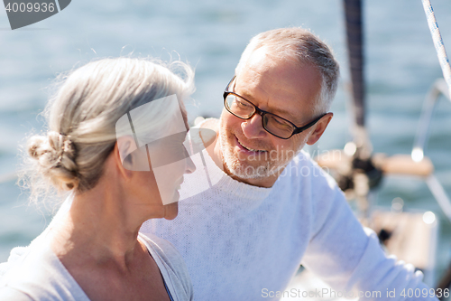 Image of senior couple hugging on sail boat or yacht in sea