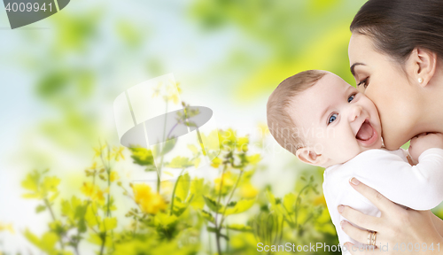 Image of happy mother kissing adorable baby