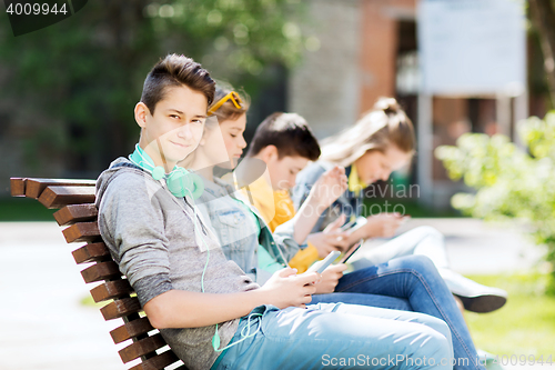 Image of happy teenage boy with tablet pc and headphones