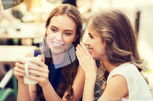 Image of young women drinking coffee and talking at cafe