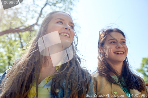 Image of happy teenage student girls or friends outdoors