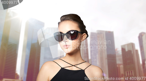 Image of beautiful young woman in elegant black sunglasses