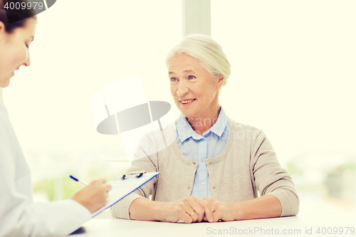 Image of doctor with clipboard and senior woman at hospital