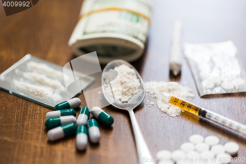 Image of close up of drugs, money, spoon and syringe