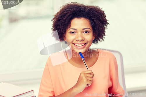 Image of happy african american woman with laptop at home