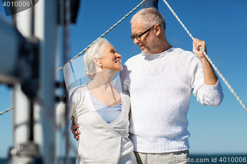 Image of senior couple hugging on sail boat or yacht in sea