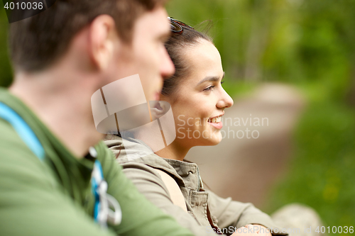 Image of smiling couple with backpacks in nature