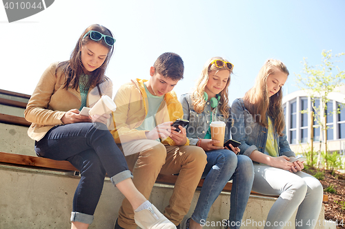 Image of teenage friends with smartphone and coffee cups