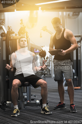 Image of man exercising on gym machine