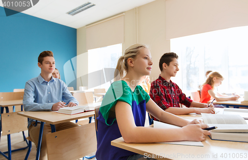 Image of group of students with books at school lesson