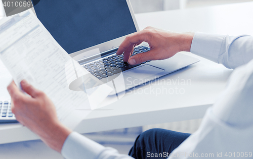 Image of miling businessman working in office