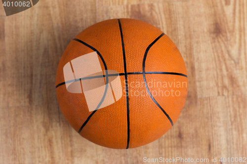 Image of close up of basketball ball on wooden floor