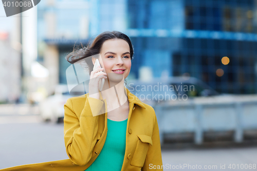 Image of smiling young woman or girl calling on smartphone