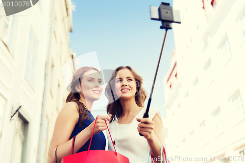 Image of women shopping and taking selfie by smartphone