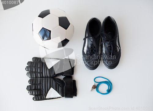 Image of close up of soccer ball, gloves, whistle and boots