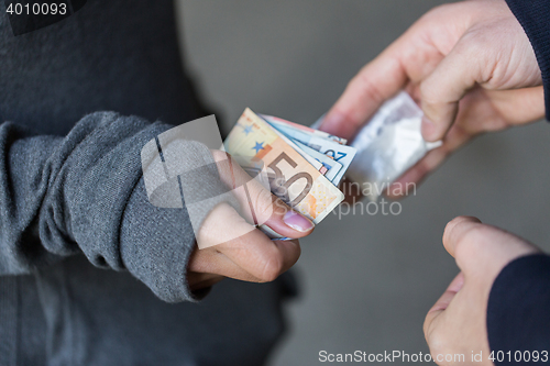 Image of close up of addict buying dose from drug dealer