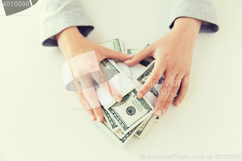 Image of close up of woman hands counting us dollar money