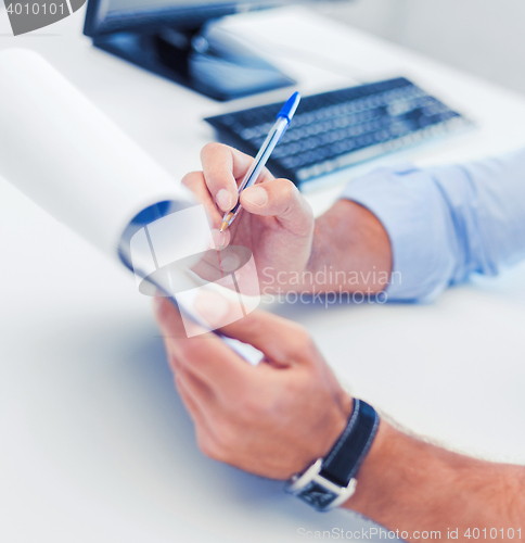 Image of businessman working and signing papers