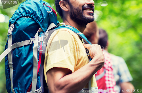 Image of close up of friends with backpacks hiking