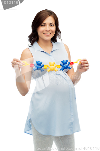 Image of happy pregnant woman holding rattle toy