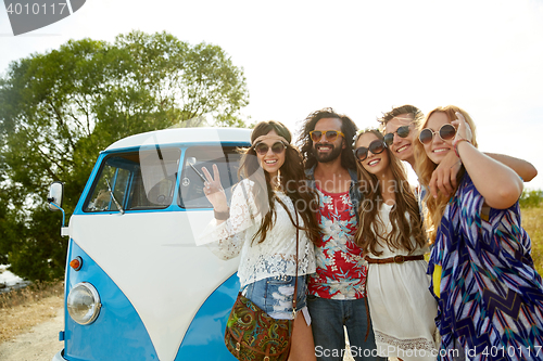 Image of hippie friends over minivan car showing peace sign