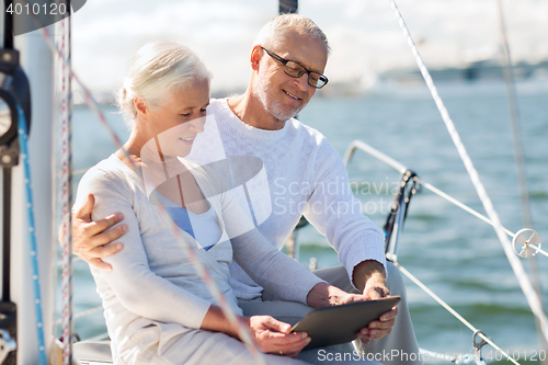 Image of senior couple with tablet pc on sail boat or yacht