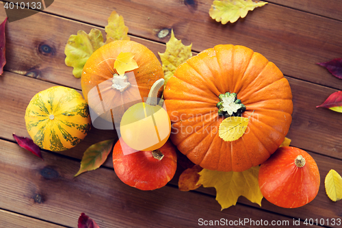 Image of close up of pumpkins on wooden table at home