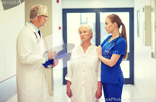 Image of medics and senior patient woman at hospital