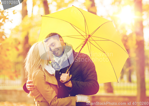 Image of romantic couple kissing in the autumn park