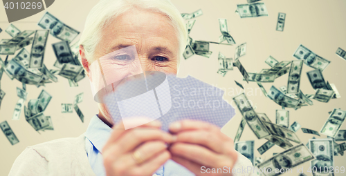 Image of close up of happy senior woman playing cards