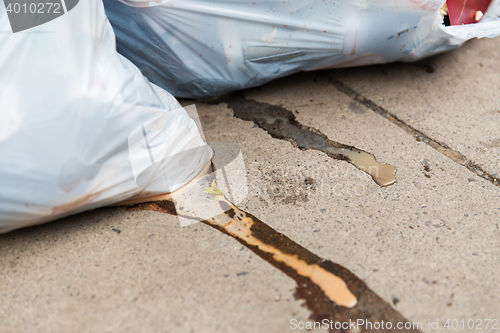 Image of close up of rubbish bags with trash outdoors