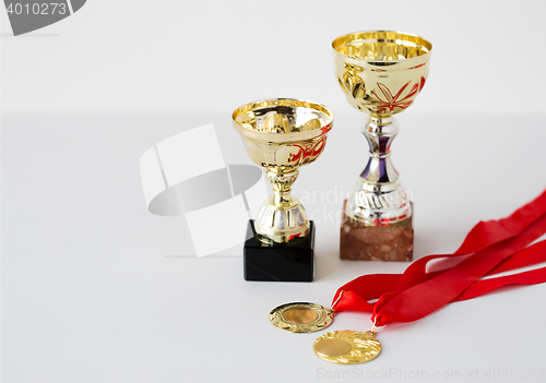 Image of close up of sports golden cups and medals