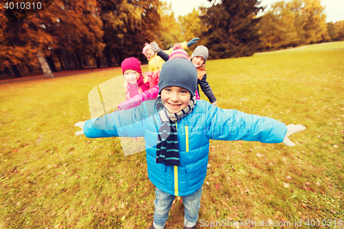 Image of happy little children playing planes outdoors