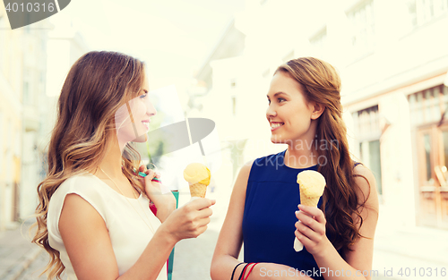 Image of woman with shopping bags and ice cream in city