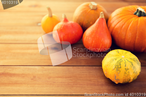 Image of close up of pumpkins on wooden table at home