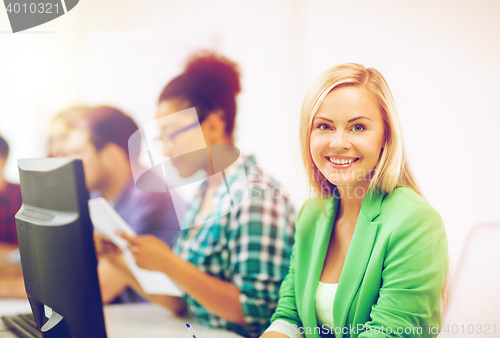 Image of student with computer studying at school