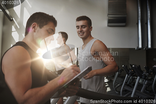 Image of men exercising on treadmill in gym