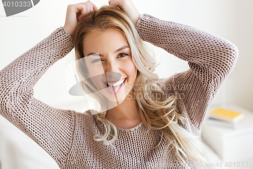 Image of happy young woman or teenage girl at home