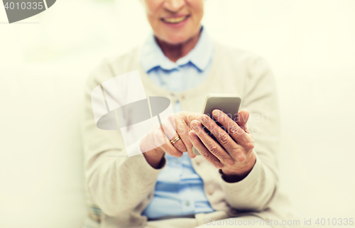 Image of close up of senior woman with smartphone texting